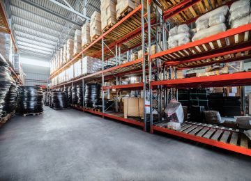 Warehouse industrial goods. Large long racks. Cardboard boxes and coiled plastic tube. Toning the image.